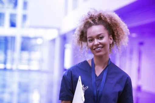 Portrait of female nurse wearing scrubs in hospital