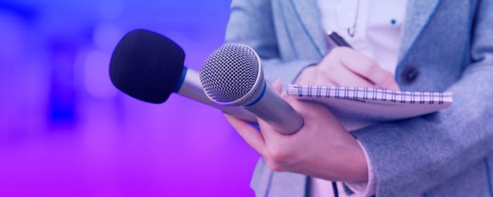 Latest press releases - microphone in front of audience