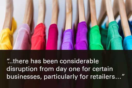 Image of hangers holding a variety of coloured tshirts, with text overlaid, "there has been considerable disruption from day one for certain businesses, particularly for retailers"