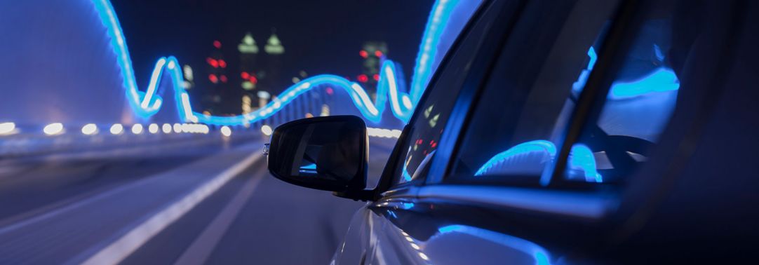 Rear view mirror of a car travelling on bridge