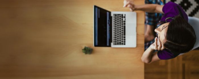 woman sitting working on a laptop