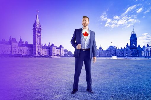 Man in suit with Canada flag on shirt in front of parliament