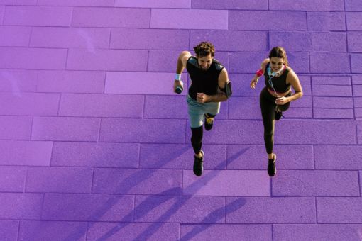 People running on a flagstone path