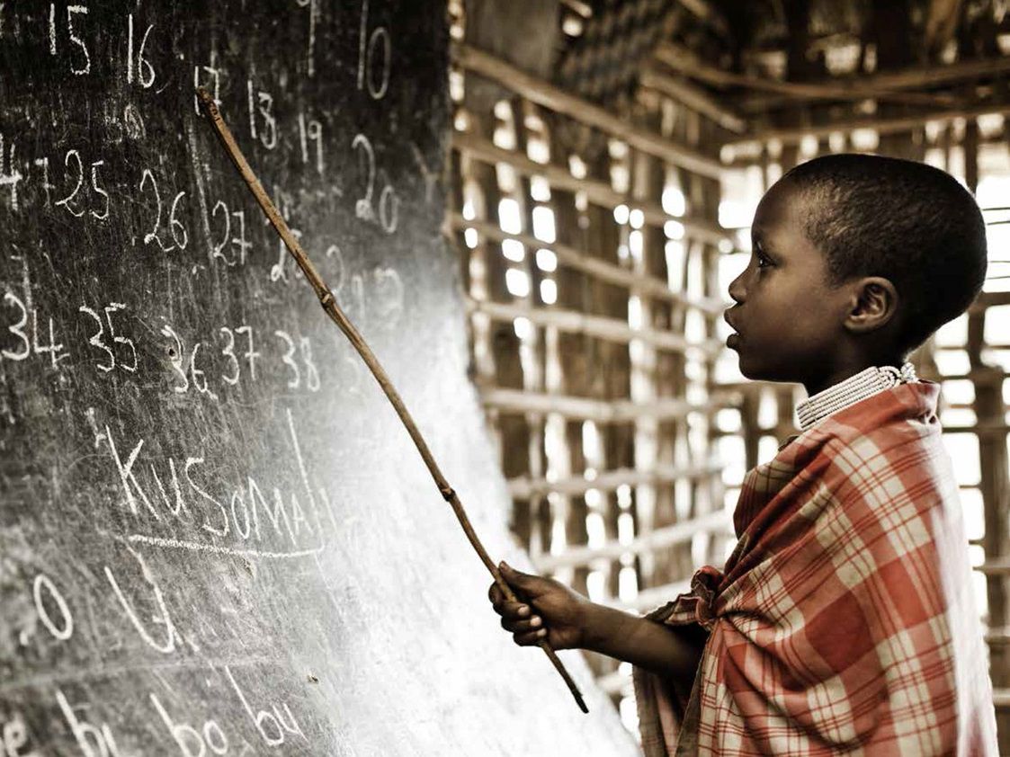 boy solving a problem on a chalkboard