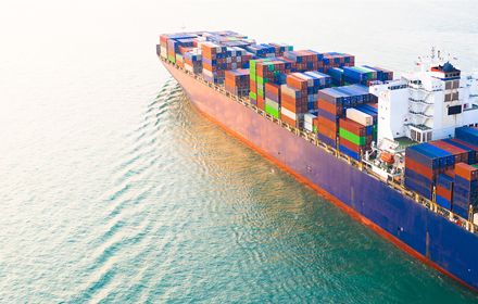ship carrying containers in sea banner
