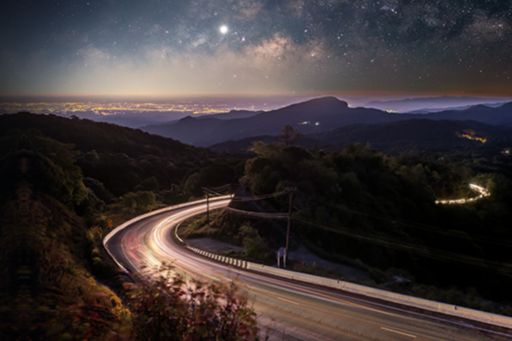 shot of mountain highway on starry night