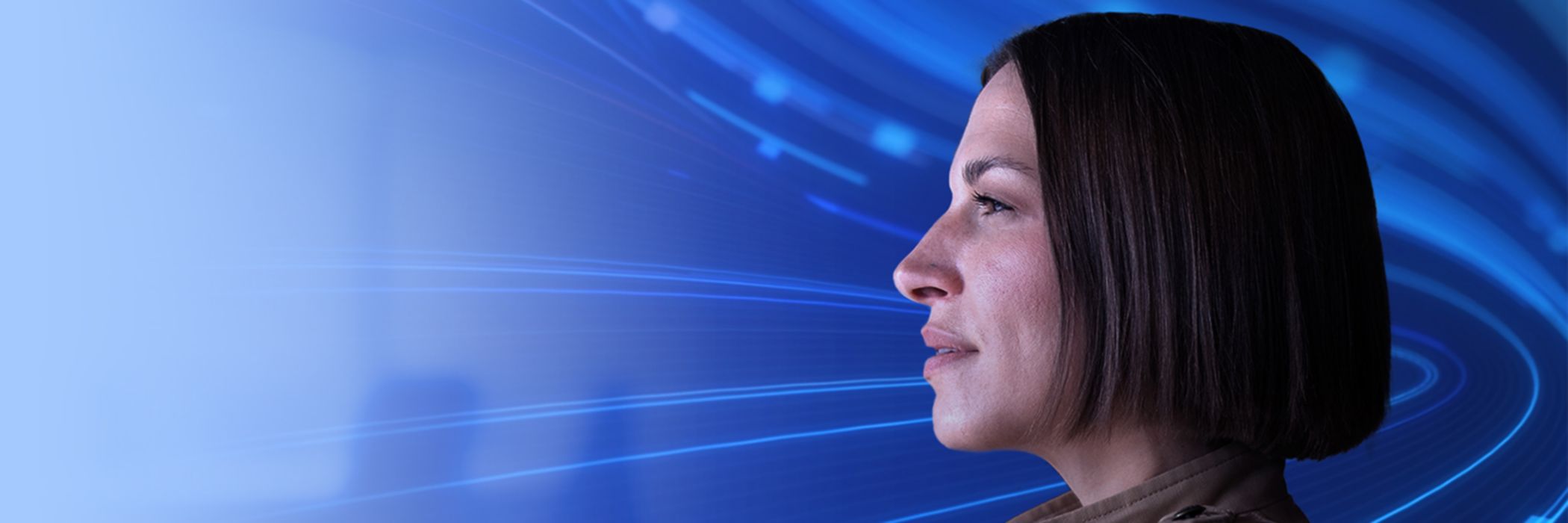 Side profile of woman with blue swirling data behind