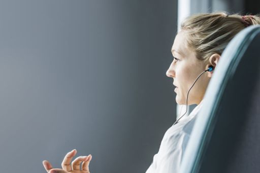 Side view of a business women talking on earphones