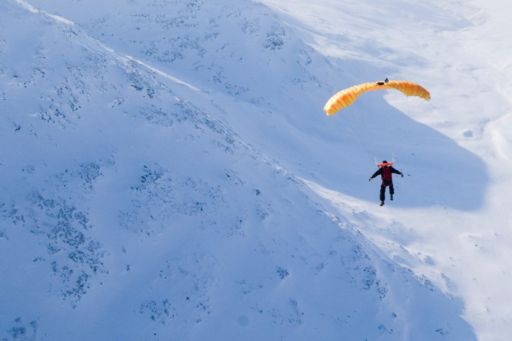 sky gliding in snowy mountains