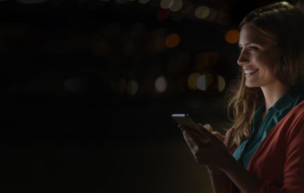 Smiling girl using phone