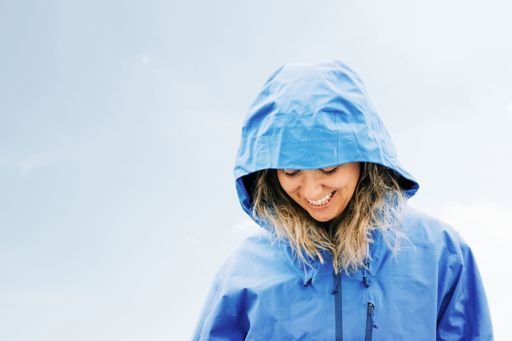Smiling woman in blue raincoat