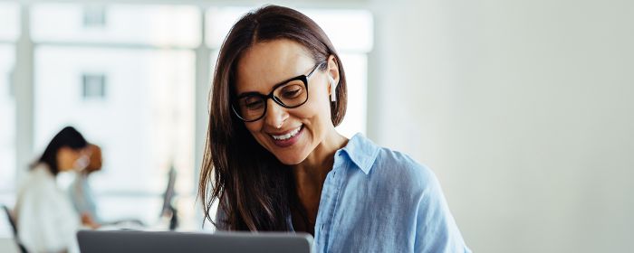 Smiling woman working on laptop