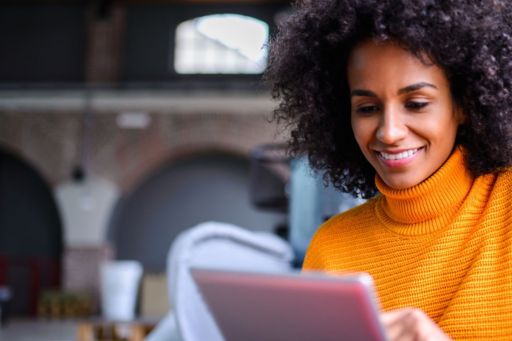 Smiling woman working on tablet