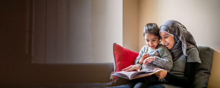 Girl wearing hijab sits with sister