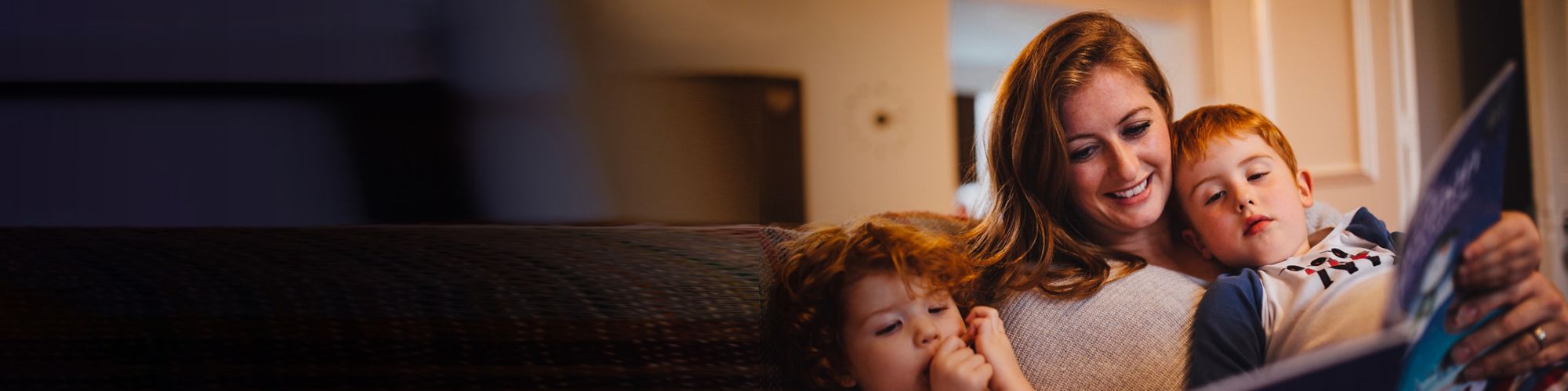 Social housing mother reading stories to young children