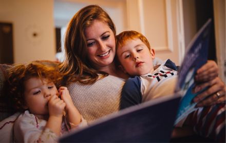 Social housing mother reading stories to young children