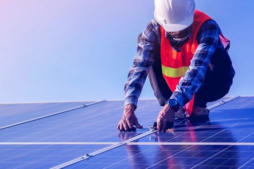 Man working on solar panels