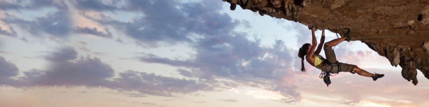 female climber hanging from mountain