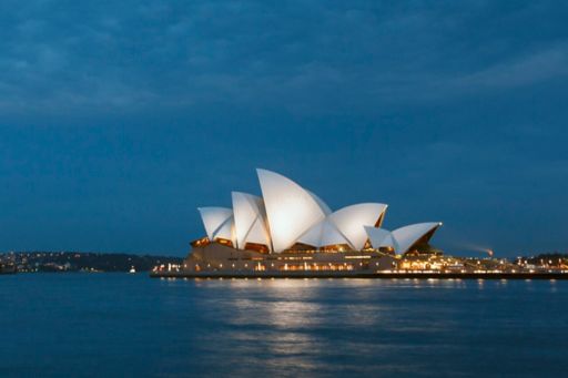 Sydney Opera House on Sydney Harbour, New South Wales, NSW Australia.  Dusk, water