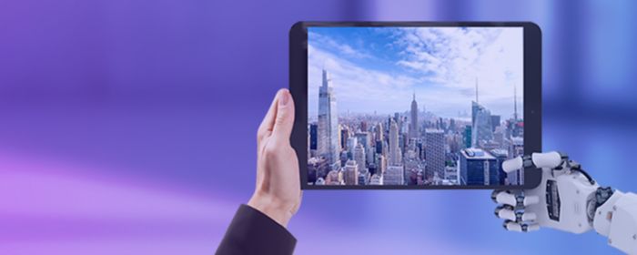 Tablet held by a human hand and a robot hand