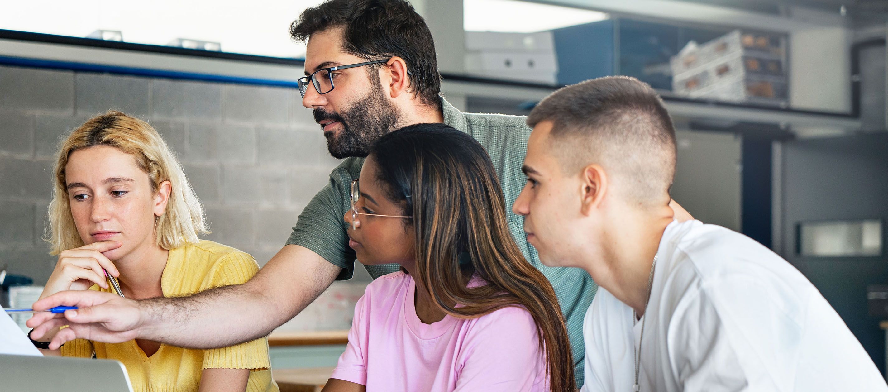 Teacher helping students