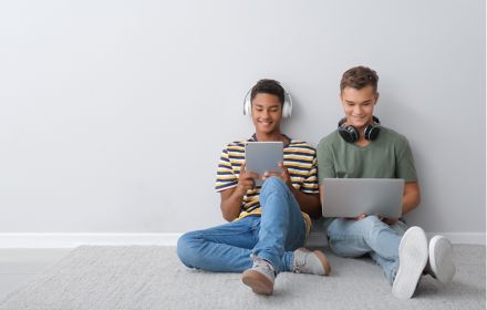 Teenage boys working on electronic devices