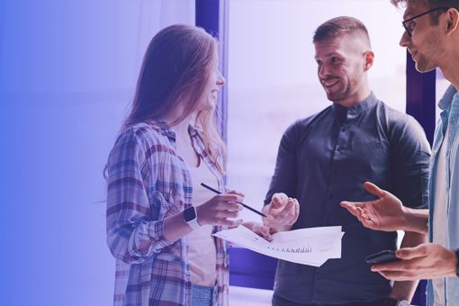 three colleagues discussing work banner