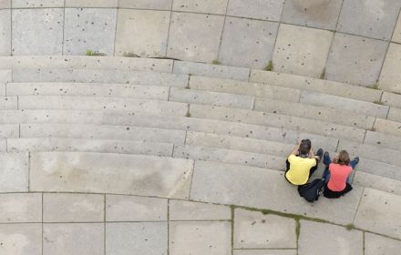 Top view of people sitting on steps