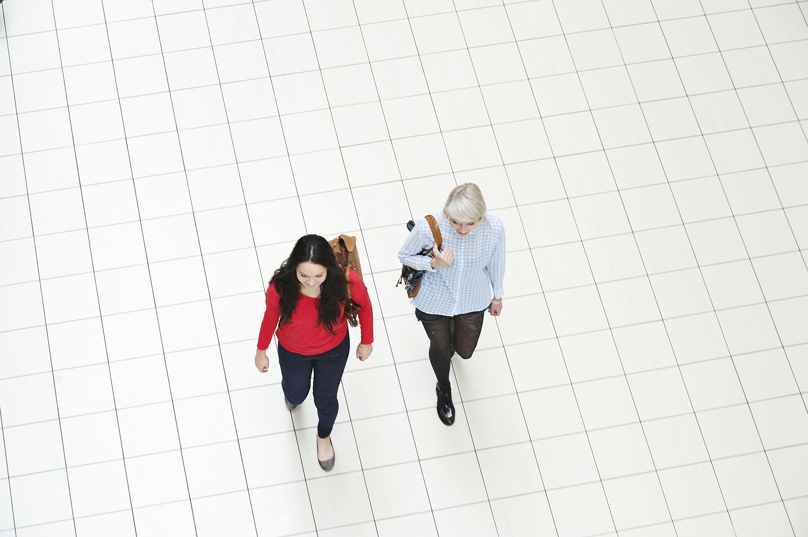 women wearing backpacks