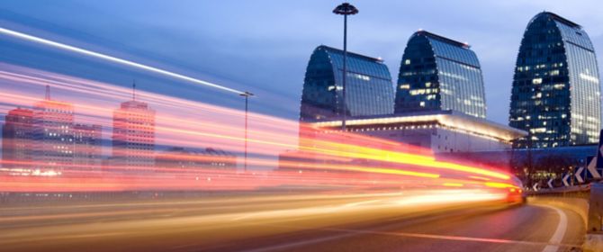 Light trails on road with building in the background