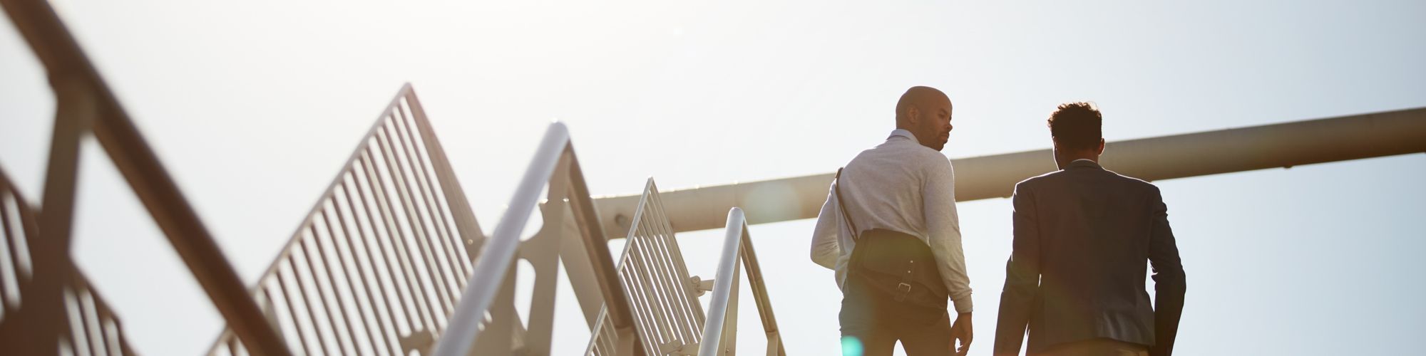 Two people standing on top of staircase