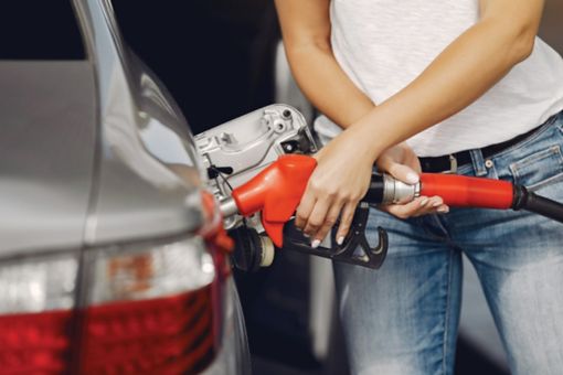Woman filling fuel in her car