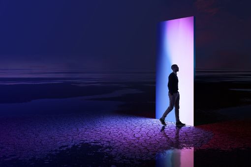 Man walking through a multi-coloured portal