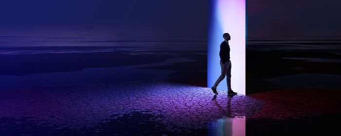 Man walking through a multi-coloured portal