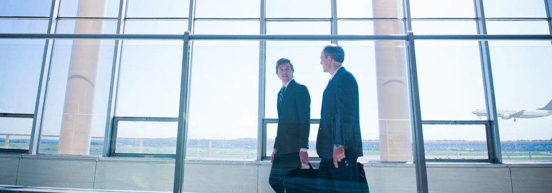 two businessmen walking in airport