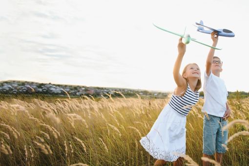 Two children holding aeroplane