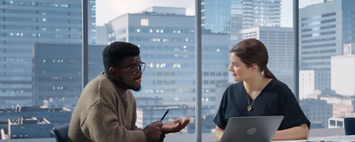Two coworkers having discussion in office