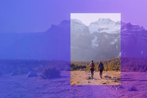 Two hikers walking on mountain path