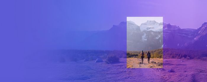 Two hikers walking on mountain path