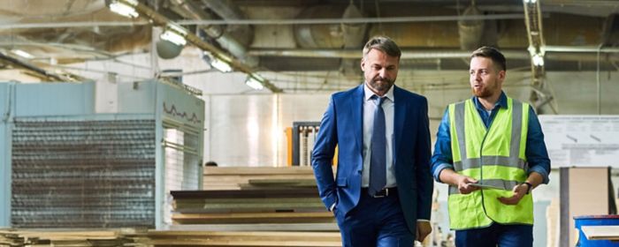 Two men walking in lumber warehouse