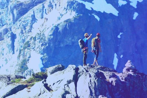 Two people climbing mountain