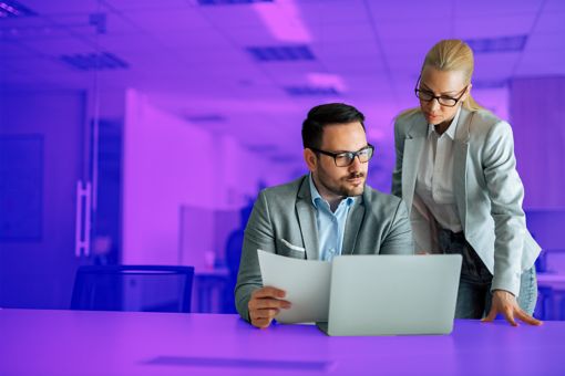 two-persons-looking-at-laptop-screen