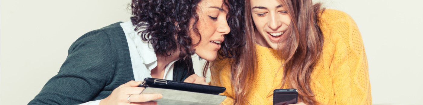 two women looking at phone data privacy article