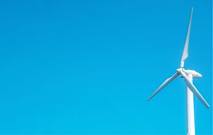 Windmill electric turbine, wind mill turbine and clean blue sky, green energy concept idea photo