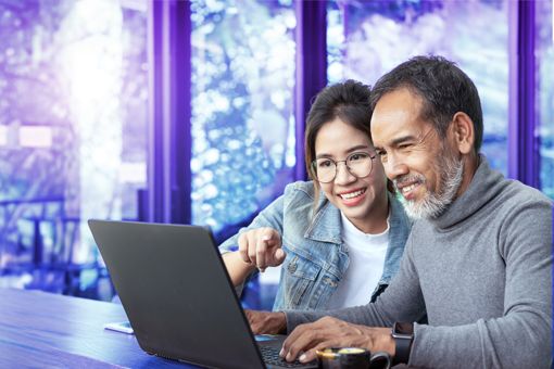 man and woman looking at laptop