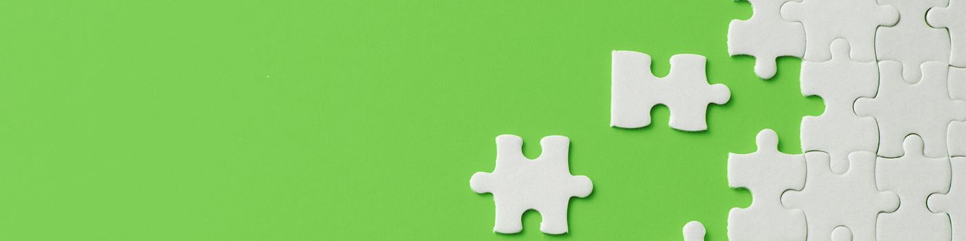 white puzzle on green background