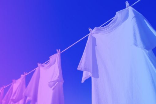 White t-shirts drying outside on a clothesline