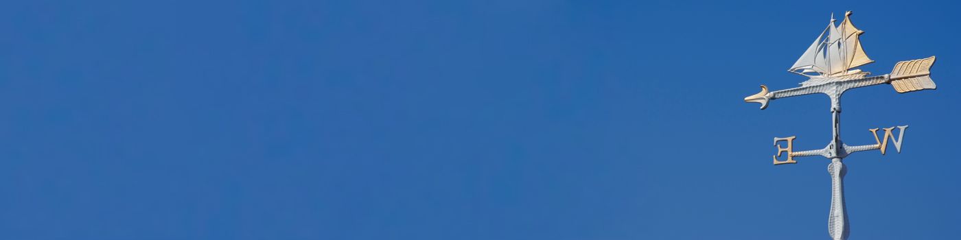 wind-vane-in-sword-form-against-blue-background-banner