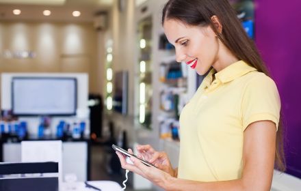 Woman choosing new mobile phone in shop