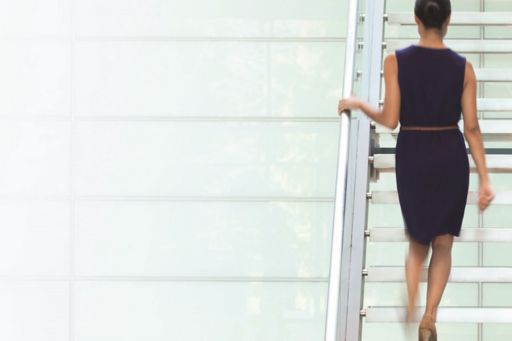 Woman climbing stairs in office